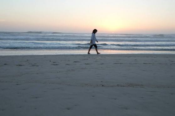 Woman walking at sunrise on Mermaid Beach. Copyright 2014 Ti-An DeMartines